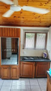 a kitchen with a stove top oven in a room at Msongi Guest House in Margate