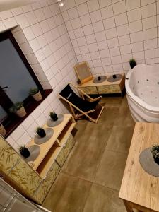 a bathroom with a tub and a sink and a toilet at Harmatówka Concept Mountain in Bukowina Tatrzańska