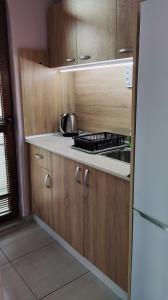 a kitchen with a stove and a white refrigerator at LILIYA Apartment in Pleven