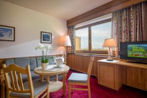 a hotel room with a table and a television at Hotel Cafe-Zillertal in Strass im Zillertal