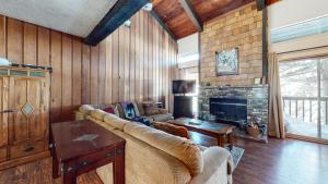 a living room with a couch and a fireplace at Chamonix Condo 94 Condo in Mammoth Lakes