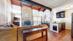 a living room with a couch and a fireplace at Chamonix Condo 94 Condo in Mammoth Lakes