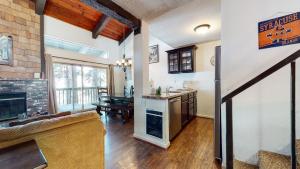 a kitchen and living room with a fireplace at Chamonix Condo 94 Condo in Mammoth Lakes