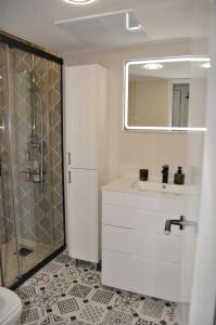 a white bathroom with a shower and a sink at Apartamento Sofia in Pineda de Mar