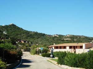 an empty road in front of a building at 4-room apartment Tanca Manna, only 300 meters from the beach in Cannigione