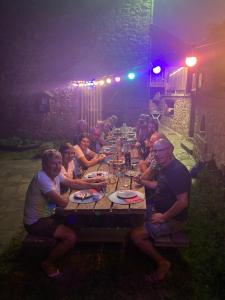 a group of people sitting at a long table at Lo Soulenquo à Fonteilles sur le GR 65 in Golinhac