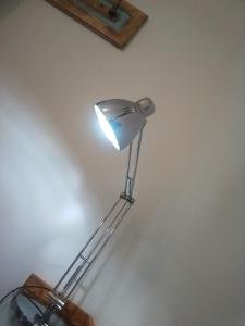 a lamp that is sitting on a wall at Piccola Casa Di Sardegna in Villanova Monteleone