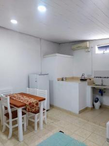 a kitchen with a table and chairs and a refrigerator at Laprida2 in Curuzú Cuatiá