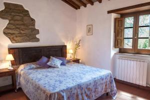 a bedroom with a bed with a blue comforter at Pilari Intera struttura in Corgna +32 photos