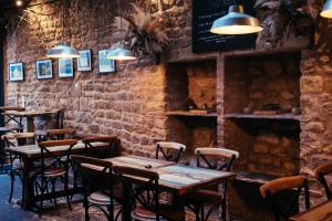 a restaurant with tables and chairs in a brick wall at The Sun Hotel & Bar in Lancaster