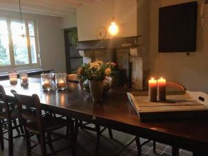 a dining room table with candles and flowers on it at BenB La Fosse Bleue in Signy-lʼAbbaye