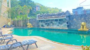 a swimming pool with two statues of monkeys in it at SM Patong Resort in Patong Beach