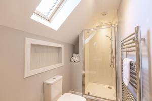a bathroom with a toilet and a glass shower at Lord Galloway 39 with Hot Tub in Newton Stewart +33 photos