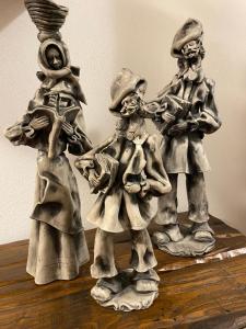 a metal statue of three people on a table at Villa Marogna in Alghero