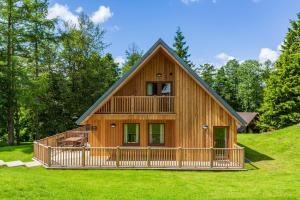 a large wooden house with a gambrel roof at Lord Galloway 39 with Hot Tub in Newton Stewart