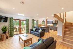 a living room with a couch and a table at Lord Galloway 39 with Hot Tub in Newton Stewart