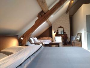 a bedroom with a large bed in a attic at BenB La Fosse Bleue in Signy-lʼAbbaye