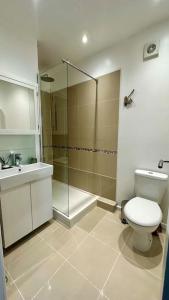 a bathroom with a shower and a toilet and a sink at Sienna's 2 - bedroom apartment, London, N1. in London