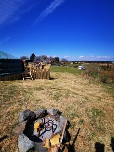 a fire pit in a field with graffiti on it at The Yurt in Newton Stewart