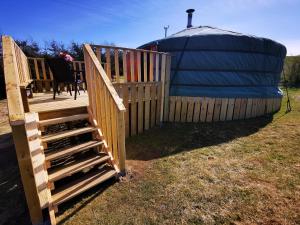 a deck with a gate and a yurt at The Yurt in Newton Stewart