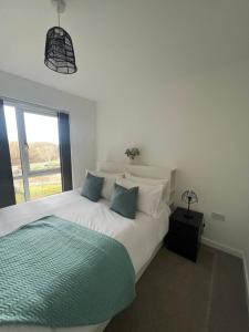 a bedroom with a large white bed and a window at Bel Home in Belvedere