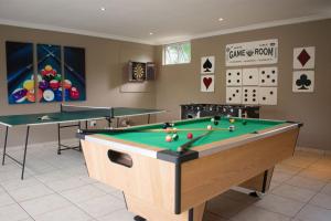 a billiard room with a pool table and two tables at Dadda's Place 2 in Port Shepstone