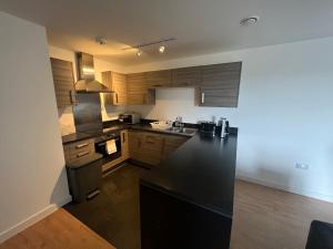 a kitchen with black counter tops and wooden cabinets at Bel Home in Belvedere