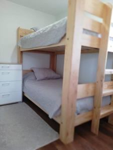 a couple of bunk beds in a room at Cabañas Kápenken, #2 in Coihaique