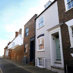 a row of brick houses on a street at Copper Fish in Deal