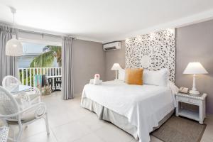 a bedroom with a bed and a balcony at Sugar Bay Barbados - All Inclusive in Bridgetown