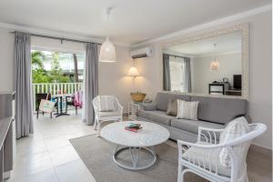a living room with a couch and a table at Sugar Bay Barbados - All Inclusive in Bridgetown