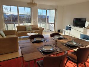 a living room with a wooden table and chairs at Traumblick in Kempten
