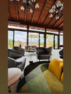 sala de estar con sofás, sillas y ventanas en Resort em pirinopolis, en Pirenópolis