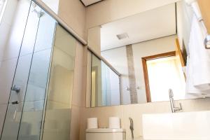 a bathroom with a toilet and a mirror at Pousada Sossego da Pampulha in Belo Horizonte +117 photos