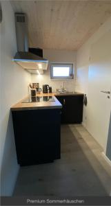 a kitchen with a sink and a counter top at Sommerhäuschen in Rheinsberg