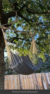 a black hammock hanging from a tree at Sommerhäuschen in Rheinsberg
