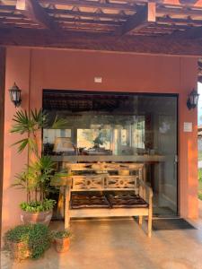 a restaurant window with a bench in front of it at Pousada Cheiro de Mato in Bonito