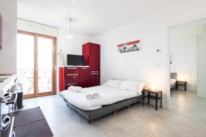 a bedroom with a bed and a red cabinet at PrimoPiano - Caduti Missione in Milan