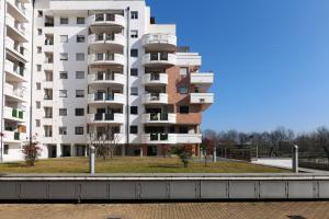 a large white apartment building with balconies at PrimoPiano - Caduti Missione in Milan
