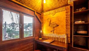 a room with a painting of a bird on the wall at Mansa Musso Treehouse Resort in Sanyang