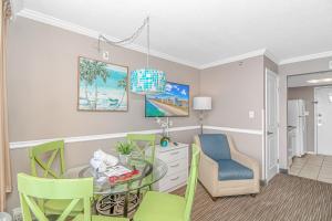 a dining room with a glass table and chairs at Caravelle 1512 in Myrtle Beach