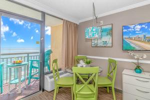 a room with a table and chairs and a balcony at Caravelle 1512 in Myrtle Beach