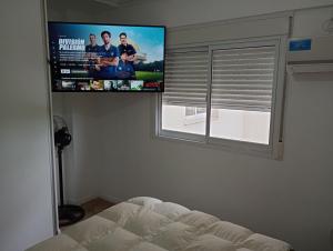 1 dormitorio con TV de pantalla plana encima de una cama en Centro 3 en Santa Fe