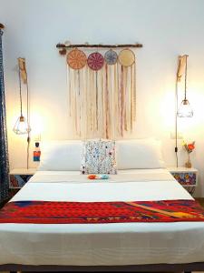 a bedroom with a large bed with decorations on it at TravelHome Serviced Apartment LPA Airport - Business - Time Off in Playa del Burrero