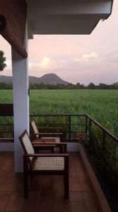 a porch with a bench and a view of a field at Takimi Mini Villa in Wellawaya