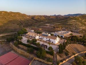 an aerial view of a building with mountains in the background at Complejo Rural Sol de Taberno in Taberno