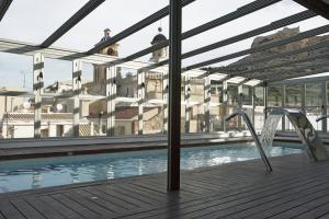 a swimming pool on the roof of a building at Hospes Amérigo, Alicante, a Member of Design Hotels in Alicante