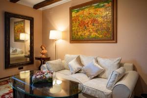 a living room with a couch and a glass table at Rigat Park & Spa Hotel - Adults Recommended in Lloret de Mar