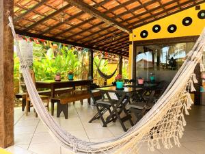 a hammock on the patio of a restaurant at Numa Boa Suites in Búzios