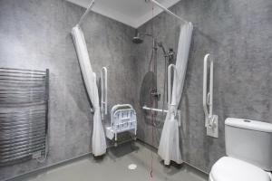 a bathroom with a shower and a toilet at SMITH PLACE HOTEL in Edinburgh